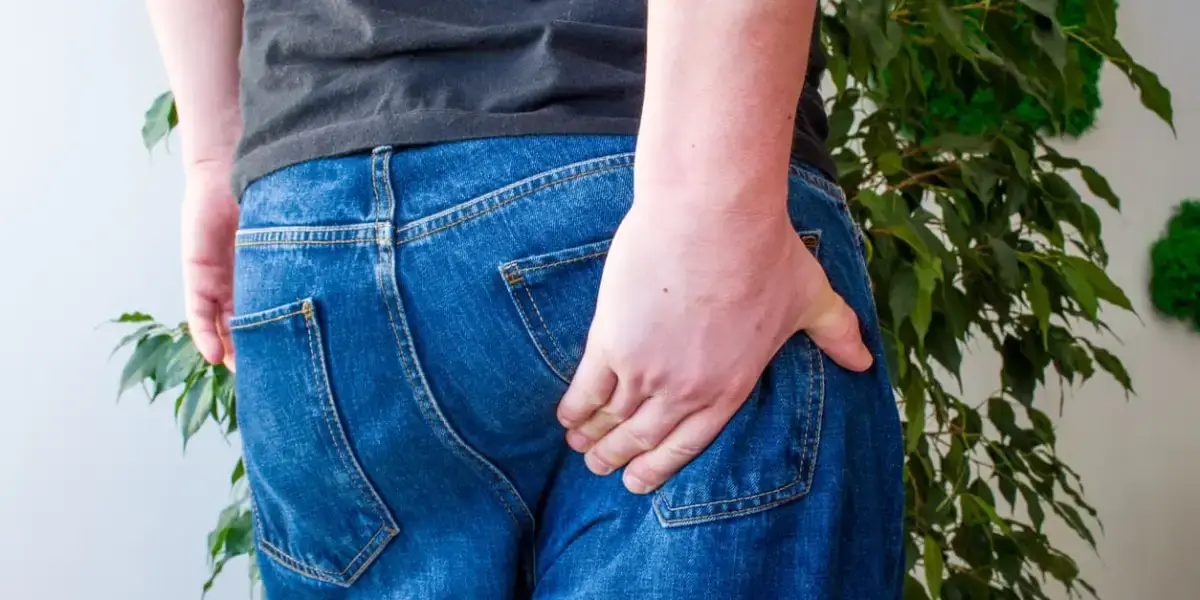 person holding their buttocks due to piriformis syndrome
