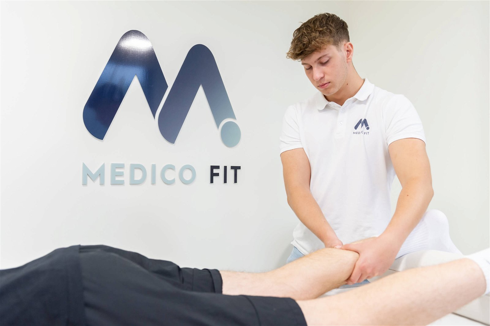 Physiotherapist massaging the calf muscle
