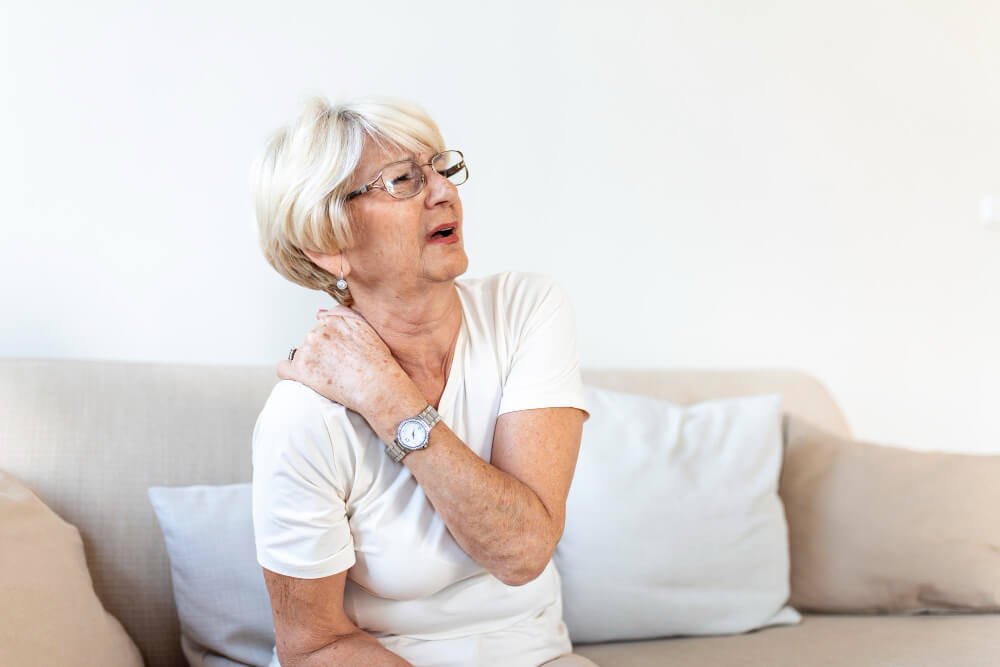 elderly woman having neck and shoulder pain